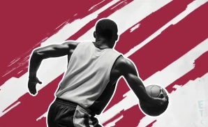 an oklahoma sooners basketball player looking down the court and dribbling the ball