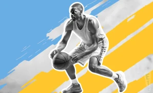 a ucla bruins basketball player looking down the court and dribbling the ball