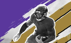 a baltimore ravens football player runs with the ball