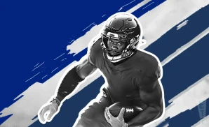 a dallas cowboys football player runs with the ball