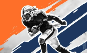 a denver broncos football player runs with the ball