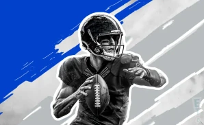 a detroit lions football player runs with the ball