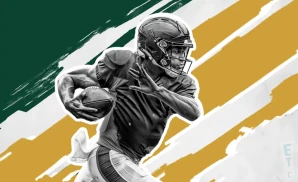 a green bay packers football player runs with the ball