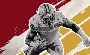 a washington commanders football player runs with the ball