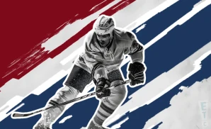 an allen americans ice hockey player about to hit the puck