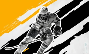 a boston bruins hockey player about to hit the puck