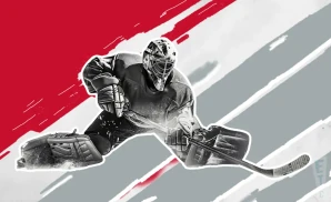 a calgary flames hockey player about to hit the puck