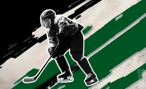 a chippewa steel ice hockey player about to hit the puck