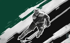 a dallas stars hockey player about to hit the puck