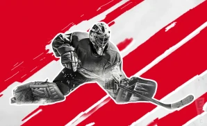 a detroit red wings hockey player about to hit the puck