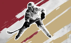 a minot minotauros ice hockey player about to hit the puck