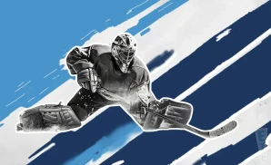 a new hampshire mountain kings ice hockey player about to hit the puck