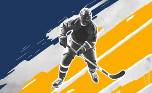 a norfolk admirals ice hockey player about to hit the puck 