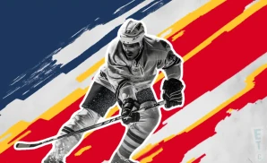 a peoria rivermen ice hockey player about to hit the puck