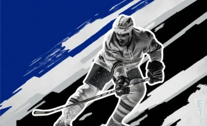 a saint john sea dogs ice hockey player about to hit the puck