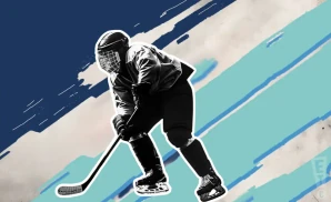 a seattle kracken hockey player about to hit the puck