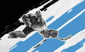 a utah hockey club hockey player about to hit the puck