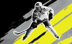 a utah outliers ice hockey player about to hit the puck