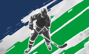 a vancouver canucks hockey player about to hit the puck