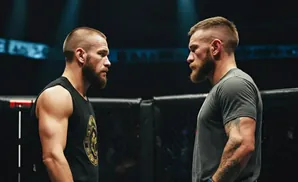 Two MMA fighters with short hair and beards face off in a ring.