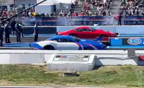 red and blue car at the starting line at nhra midwest nationals 2022 at the world wide technology raceway in madison, illinois.
