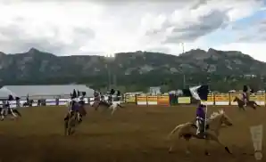 cowboys riding around at rooftop rodeo in estes park, colorado.