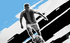 a charlotte fc soccer player kicking the ball down field 