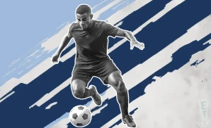 a sporting kansas city soccer player kicking the ball down field 