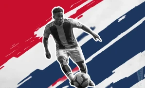 a st louis city sc soccer player kicking the ball down field