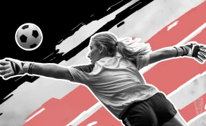 an angel city fc goalie soccer playerdiving to catch the ball