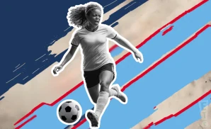 an ol reign soccer player kicking the ball down field