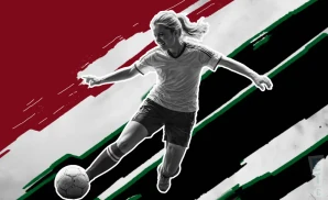 a portland thorns fc soccer player kicking the ball down field