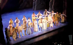 the cast of frozen the musical bowing on stage at sarofim hall in houston, texas.