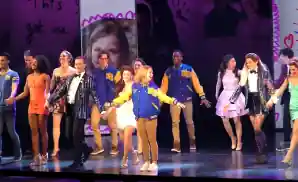 the cast of mean girls together on stage.