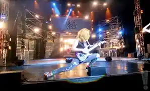 rock of ages electric guitarist playing on stage.