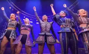 cast performing in the musical six on stage with confetti falling down.