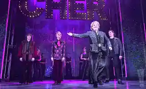 the cast of the cher show performing on stage.