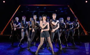 chicago the musical band playing on stage with the logo above them.