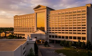 A large hotel with golden windows at sunset.