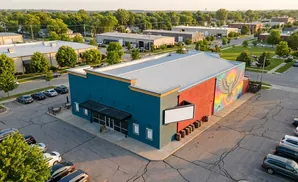 A brightly colored building with a mural of a bird.