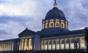 The Oklahoma State Capitol building at dusk with a cloudy sky.