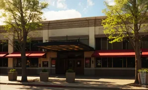 Exterior of a building with red awnings over windows and a covered entrance.