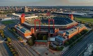 Aerial view of a stadium with red towers and buildings.