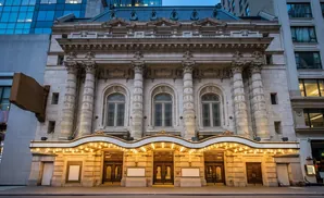 Grand theater entrance with ornate architecture and illuminated marquee.
