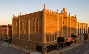 Art deco theater with ornate facade at sunset.