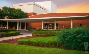 Modern brick building with white accents and a covered entrance.