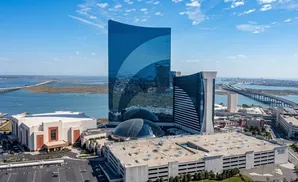 Aerial view of the Hard Rock Hotel & Casino Atlantic City, featuring its iconic guitar-shaped building and surrounding infrastructure.