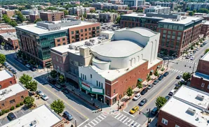Aerial view of a city intersection with a theater and brick buildings.