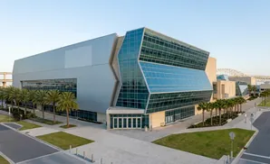 A modern convention center with a large silver facade and a glass-fronted section.