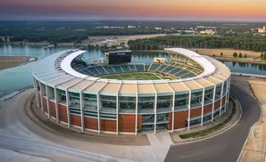 Aerial view of a baseball stadium next to a river at sunset.